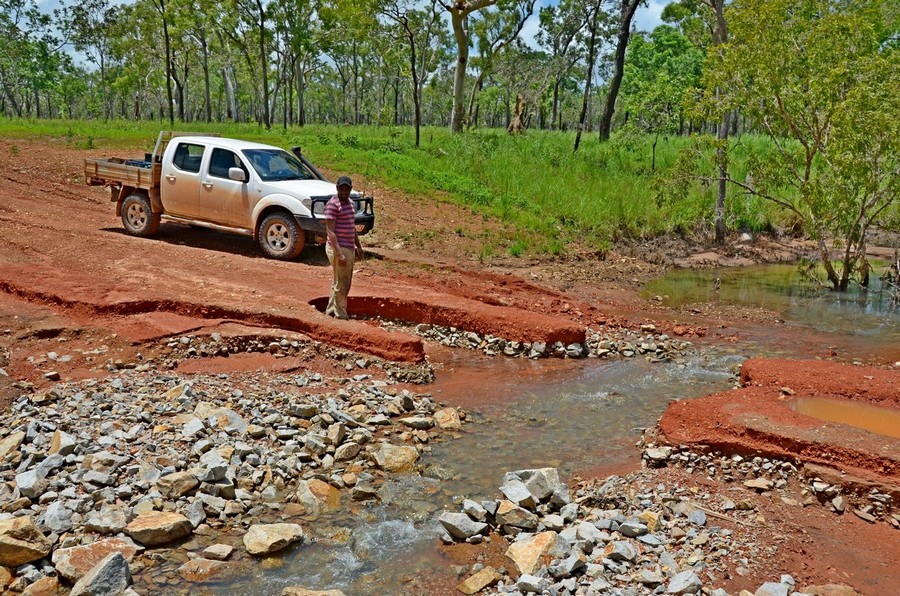ute and man next to road washout
