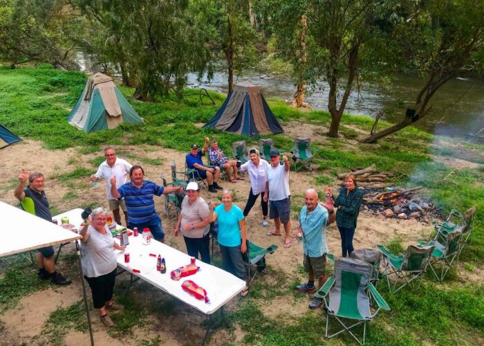 People bush camping by river