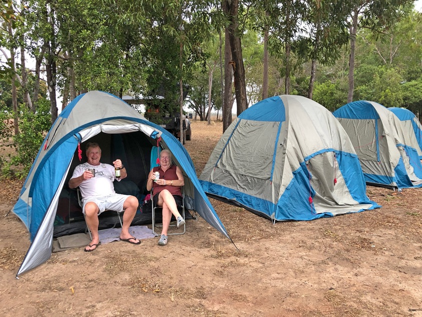 couple sitting at door of tent