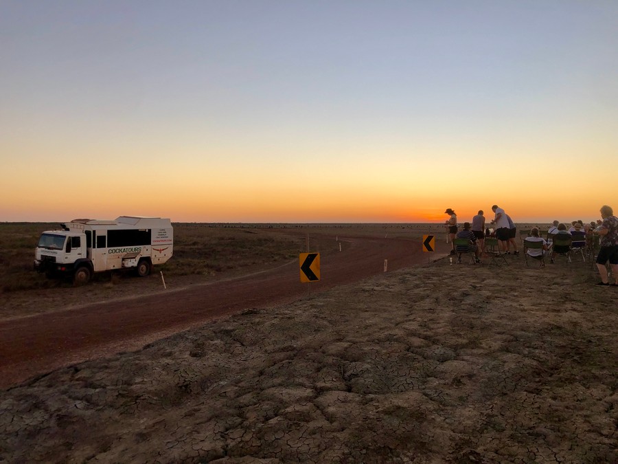 tour truck and people watching sunset in cape york