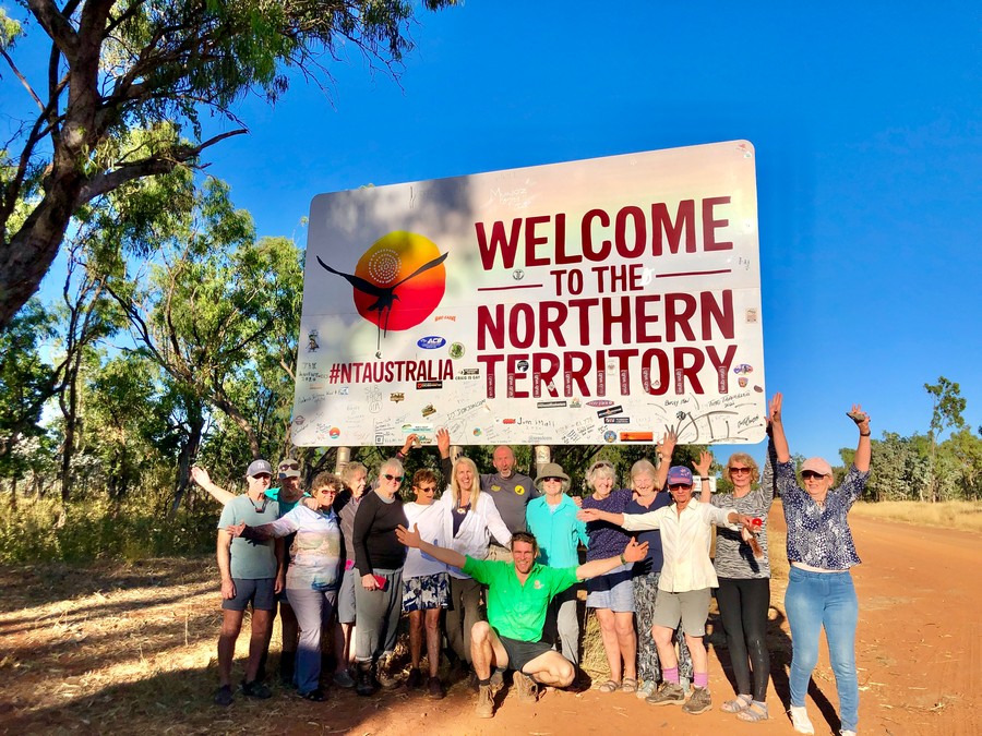 people at northern territory border sign